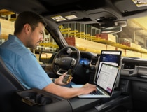 Man in driver's seat of Ford F 150.