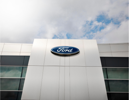 Red Ford Super Duty pulling a tractor