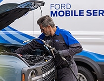 Ford Mobile Service technician working on a vehicle