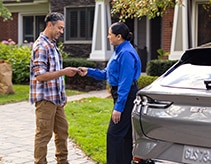 Customer and technician with vehicle and Ford Mobile Service van