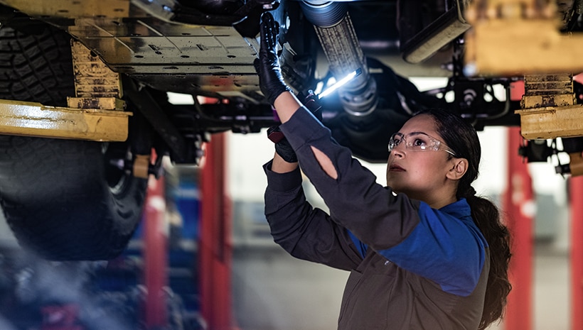 Service technician changing a vehicle’s oil