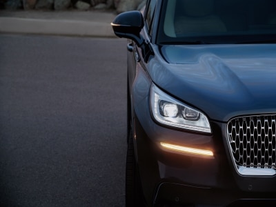 A hand with an e-pen signing a form on a tablet