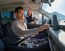 Client in vehicle with Lincoln technician standing nearby