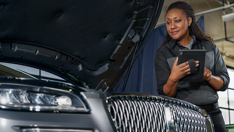 Lincoln technician with vehicle in service bay