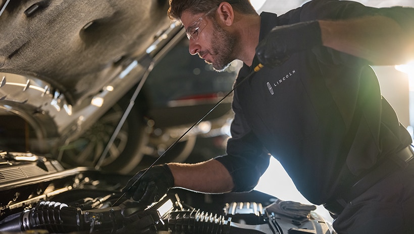 Lincoln technician checking vehicle fluid