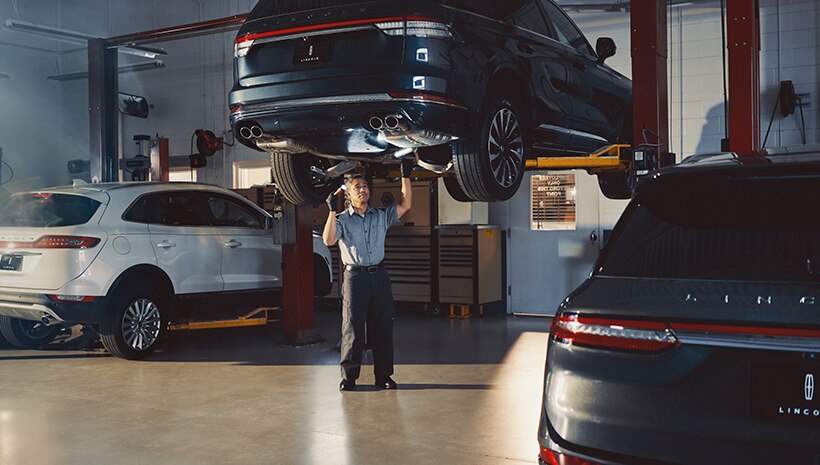 Lincoln technician with vehicle in service bay