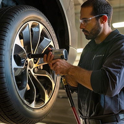 Lincoln technician with a tire