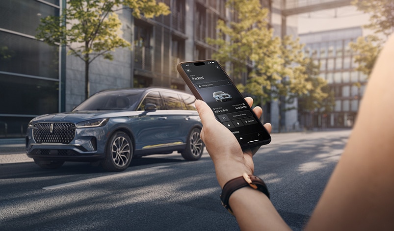 Woman using smart phone to access Lincoln app.