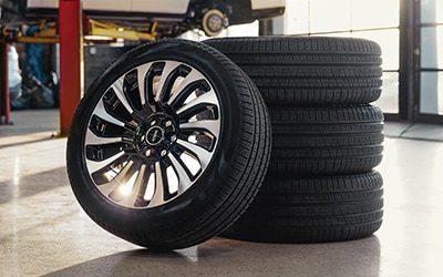 Stack of four tires in service bay.
