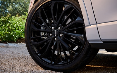 Wheel and tire of a Lincoln vehicle.
