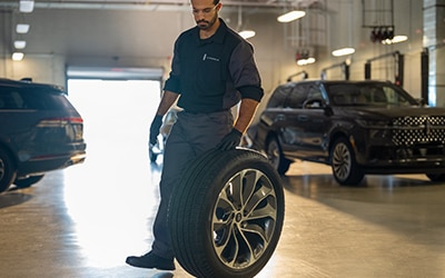 Lincoln technician with a tire