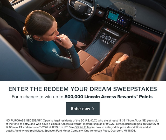 A person is sitting in a Lincoln vehicle