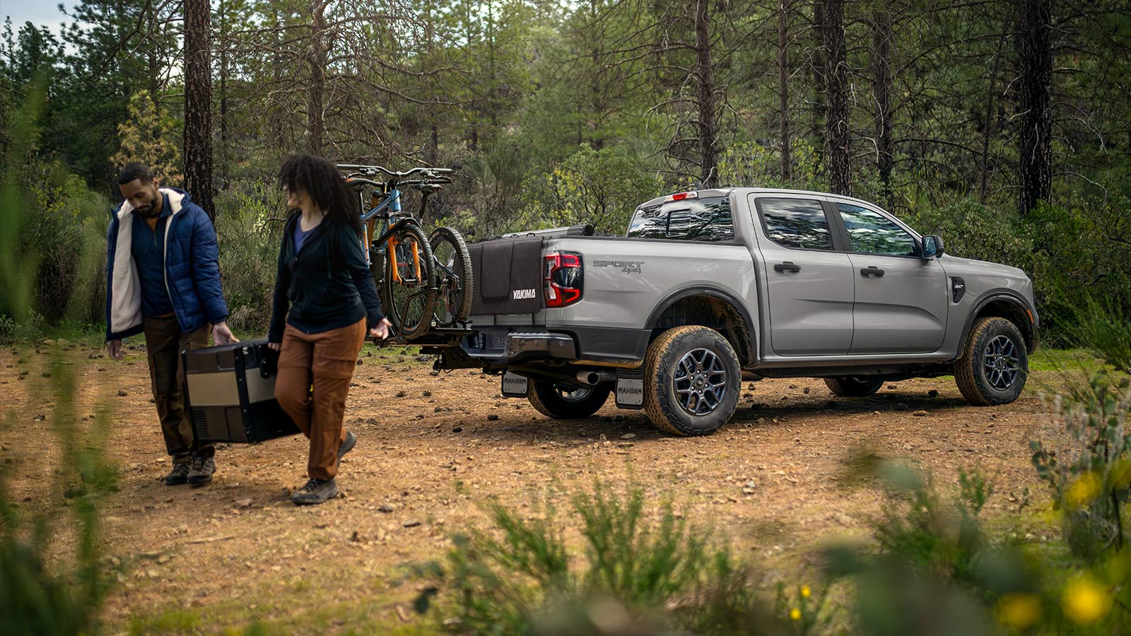 Two campers retrieve a cooler from their Ranger® pickup.
