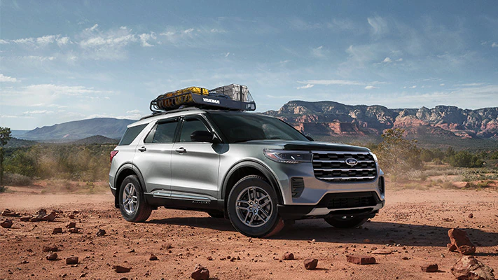 The Explorer® SUV parked on a desert flat with mountains off in the distance.