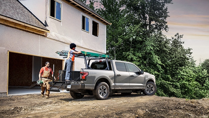 The F-150® Lightning® truck gets work done outside a new home build.