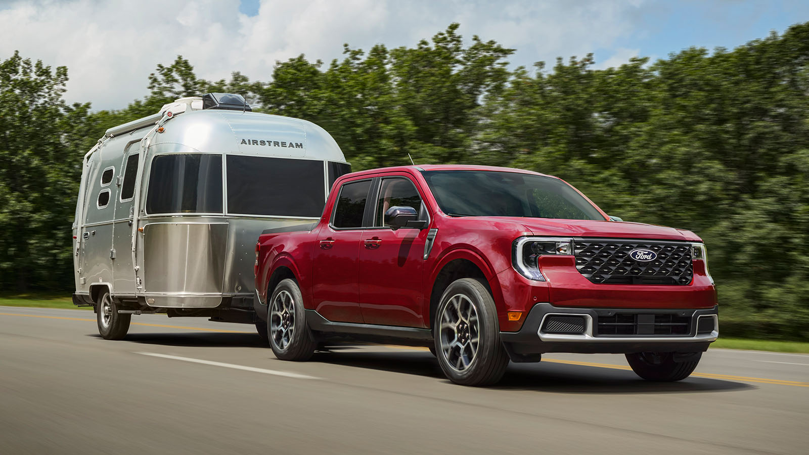 A Maverick pickup® tows an Airstream trailer down the road.