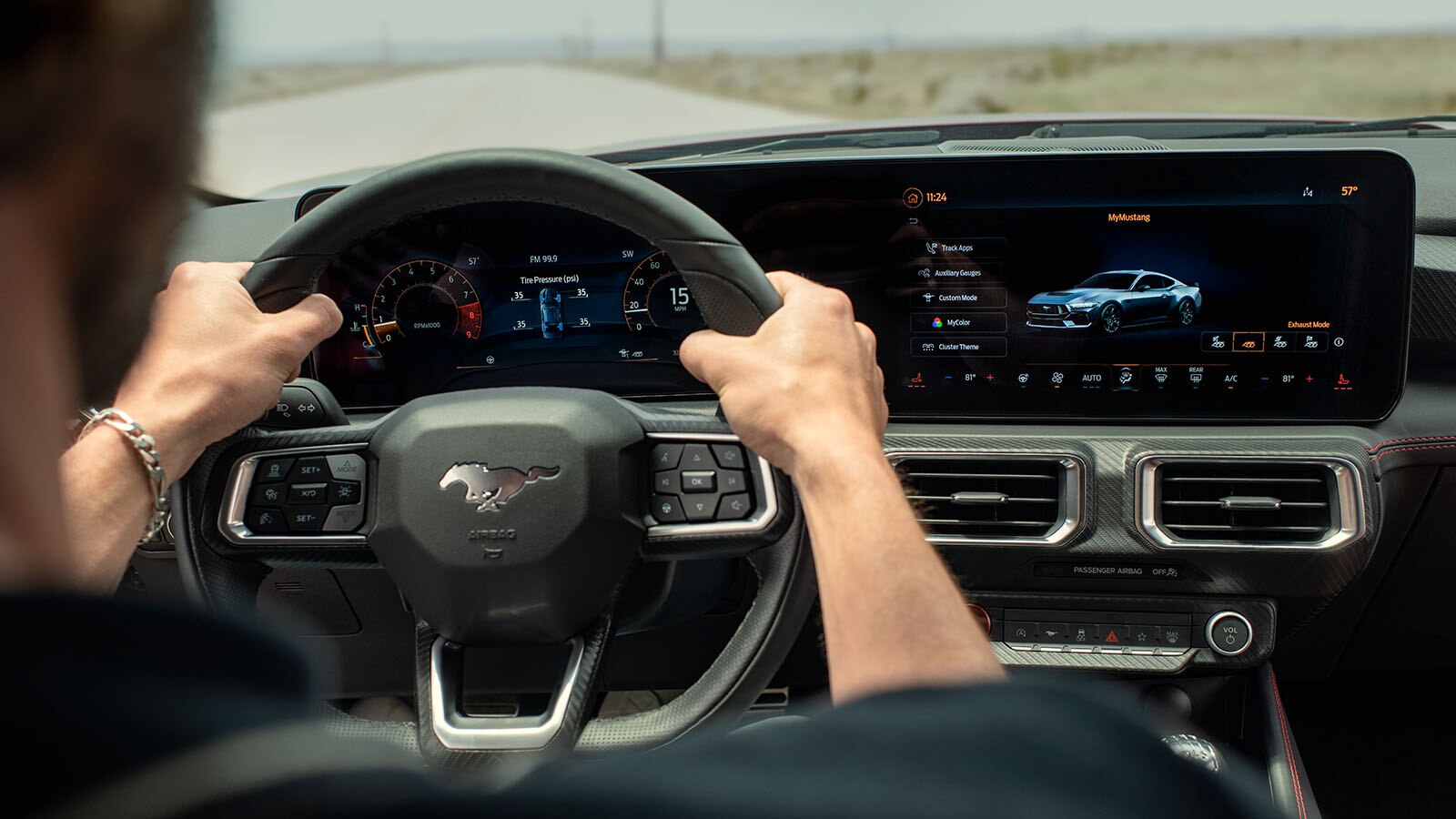 The driver grips the steering wheel ready to charge down the road.