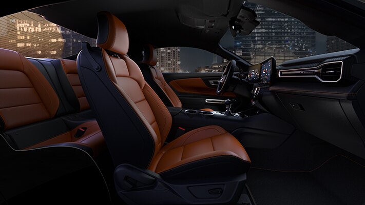 The performance interior of the Mustang® coupe illuminated by the ambient light of the city at night. 